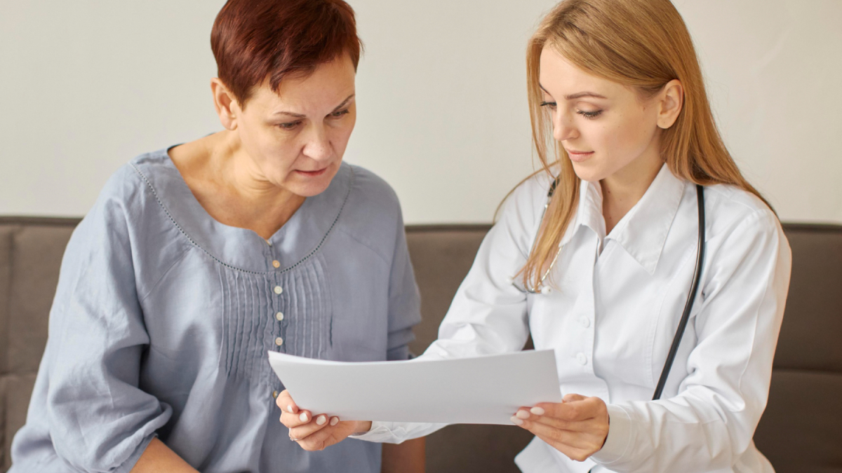 Female physician reviewing pharmacogenetic test results with a patient during a consultation