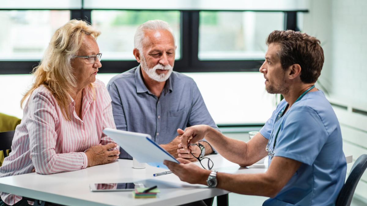 pharmacogenetics: Mature couple receiving personalized preventive healthcare guidance from a specialist
