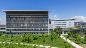 Panoramic view of a modern Swiss hospital building featuring contemporary architecture and state-of-the-art medical facilities in the heart of the Swiss Alps